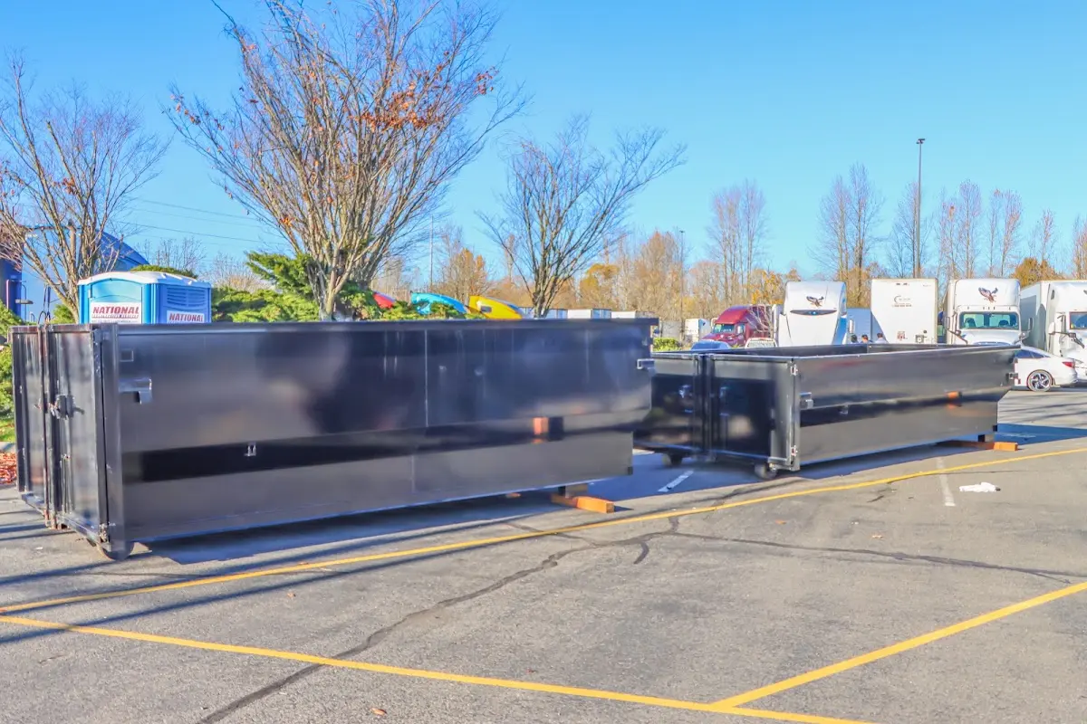 Professional dumpster rental service with roll-off container on residential driveway in Murillo